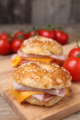 Delicious bagels with ham and cheese on table