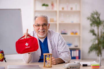 Old male doctor paramedic in time management concept