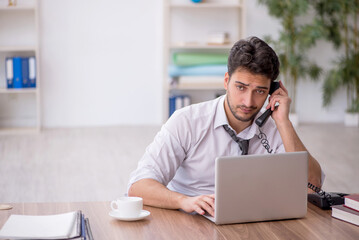 Young male employee working in the office