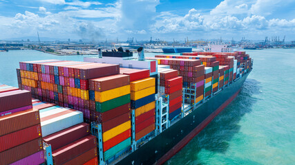 Stern of large cargo container ship import export container box on the ocean sea on blue sky back...