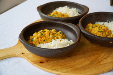 Close up view of 3 ceramic bowls with chickpeas curry with rice. An excellent alternative for healthy cooking-