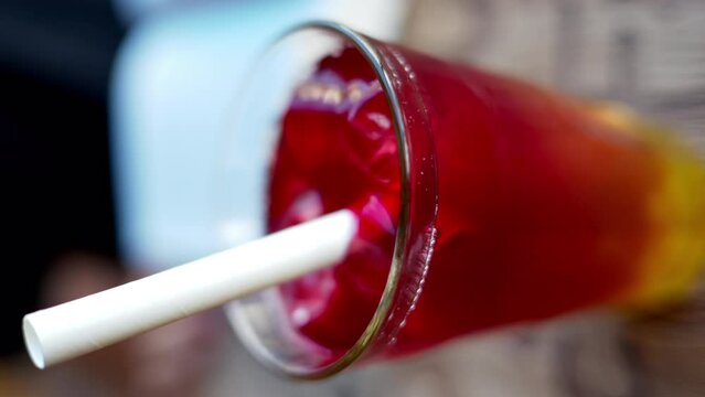 Red bubble tea in a glass with ice