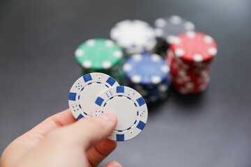 High-stakes Texas Hold'em poker chips and cards symbolize risk, chance, and adrenaline in gambling at the casino. Bet for fortunes
