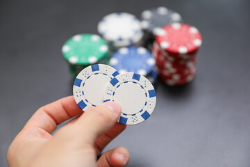 High-stakes Texas Hold'em poker chips and cards symbolize risk, chance, and adrenaline in gambling at the casino. Bet for fortunes
