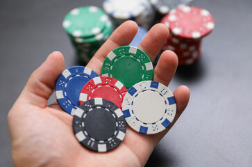 High-stakes Texas Hold'em poker chips and cards symbolize risk, chance, and adrenaline in gambling at the casino. Bet for fortunes