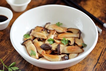 Fried sliced king oyster mushrooms in soy sauce