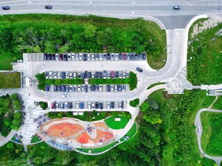 Aerial view of Lake Wilcox community park in Richmond Hill, Ontario, Canada. Top view of parking lot, kids playground and nature trees surrounding. 