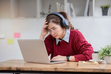 Stress, student with laptop at home frustrated angry unhappy young woman looking at laptop screen book, Exhausted female student studying online with computer