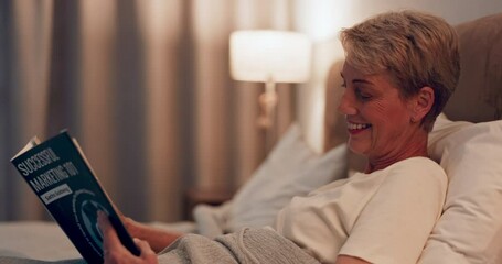 Senior woman in bed, reading book and happy with night routine, retirement and relax with literature. Story, fiction and female person in bedroom, knowledge and hobby with smile and reader at home