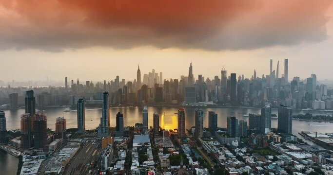 Overcast skies above Manhattan. New York downtown cityscape at orange sunset. Top view.