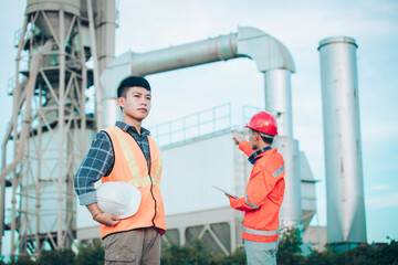 Couple worker happy teamwork standing together friendly smiling enjoy working industry at plant the production of concrete. Engineers asian standing confident with friend.