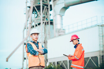 Couple worker happy teamwork standing together friendly smiling enjoy working industry at plant the production of concrete. Engineers asian standing confident with friend.