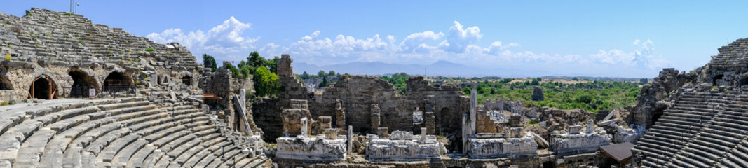 Fototapeta na wymiar Side Ancient theatre. Turkey. Antalya. Ruins of the ancient city of Side. The largest amphitheater in Turkey. Main street of the ancient city. Mediterranean Sea.