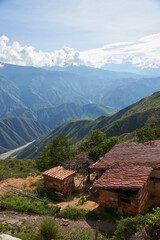 Fototapeta na wymiar Rural house in the Chicamocha Canyon area, mountainous Andean scenery in Santander, Colombia under the morning sunlight.