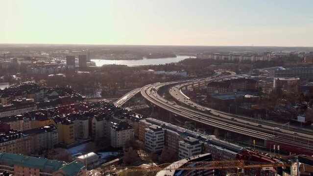 Aerial tracking video of highway in Stockholm during sunset. Lake M&auml;laren in the background. 
