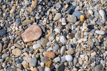 Crushed stone on the seashore. Selective focus on object. The stones were laid on the ground in the garden as a background. Background blur. Pebble stones background.