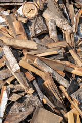 A large pile of different sawn firewood for the stove. Preparing firewood for the winter. Firewood background.