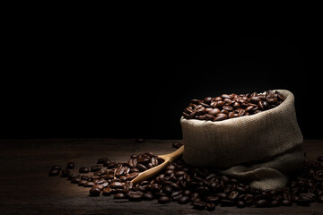 coffee beans in sacks on wooden background