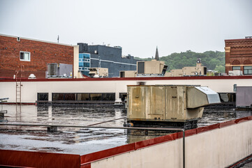 Rooftop industrial air handler during a rain storm. 