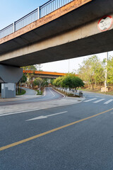 Concrete structure and asphalt road space under the overpass in the city - 630180330