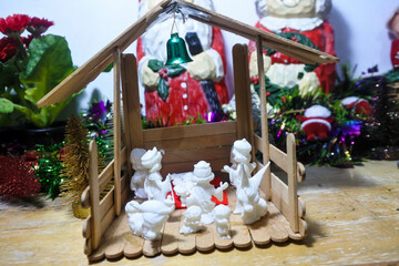 Charming miniature Christmas crib scene with detailed figurines and festive decorations