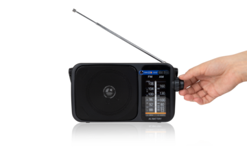 Radio receiver on a white background. Black portable wireless radio close-up isolated on a white background.