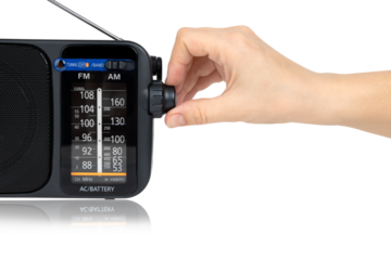 Radio receiver on a white background. Black portable wireless radio close-up isolated on a white background.