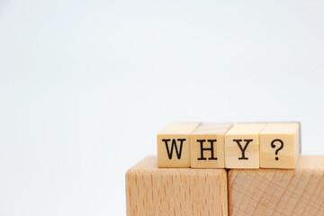 the word "why?" on wooden cubes