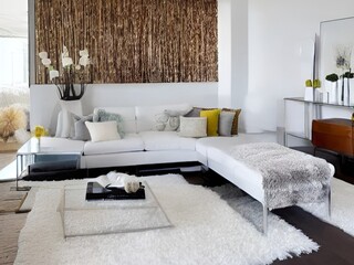 living room with a couch, a television and wall and lamp and table and charis and plant