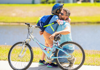 daddy and son kid outdoor. daddy and son spend time together. Creating cherished family memories. happy son and daddy cycling on bicycle. daddy teaching his son child to ride a bicycle