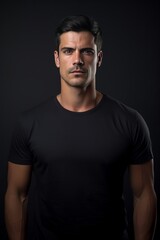 Fototapeta premium Man in black tshirt isolated on black background.