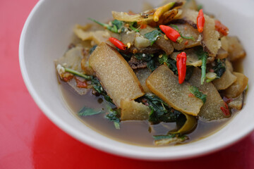 Beef skin curry, on white bowl, cook from dried fermented buffalo or cow skin as food preservation, curry with herbs Concept, Thai local food, traditional eating style.                         