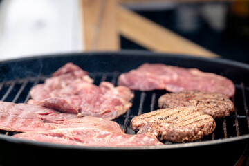 Raw meat and meat grilled on the grill