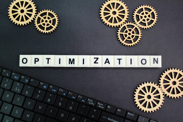 gear teeth with the word Optimization. technology concept and optimization. the action of making...