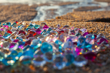 Colorful diamonds on the beach..Each diamond caught the glimmer of the sun, glistening in the sand..The sparkles of the diamonds lit up the shoreline, creating a mesmerizing landscape..