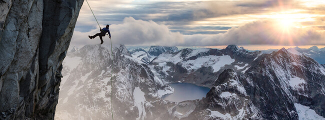 Epic Adventurous Extreme Sport Composite of Rock Climbing Man Rappelling from a Cliff. © edb3_16