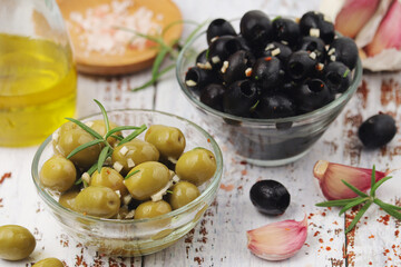 Black and green olives in glass bowls