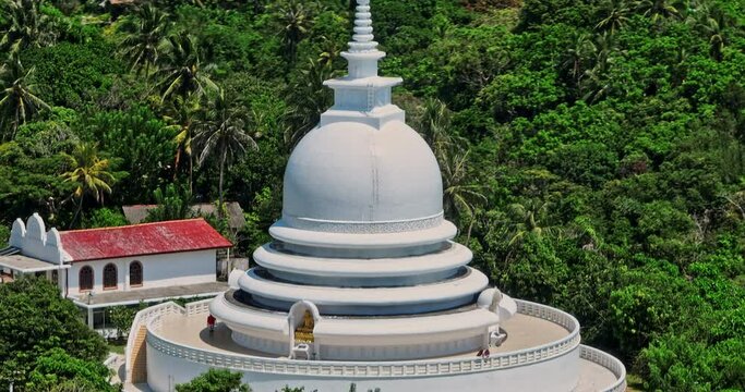 Unawatuna Sri Lanka Aerial v11 close up drone flyover and around Japanese Peace Pagoda on the Rumassala hill hidden amongst the trees of the rainforests - Shot with Mavic 3 Cine - April 2023