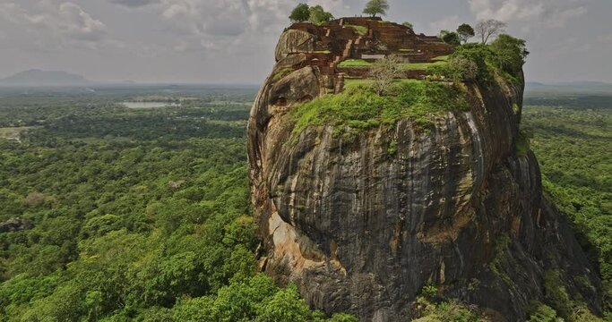 Sigiriya Sri Lanka Aerial v7 drone fly around historical and archaeological site capturing ruins of ancient city and fortress built on top of Sigiriya lion rock - Shot with Mavic 3 Cine - April 2023