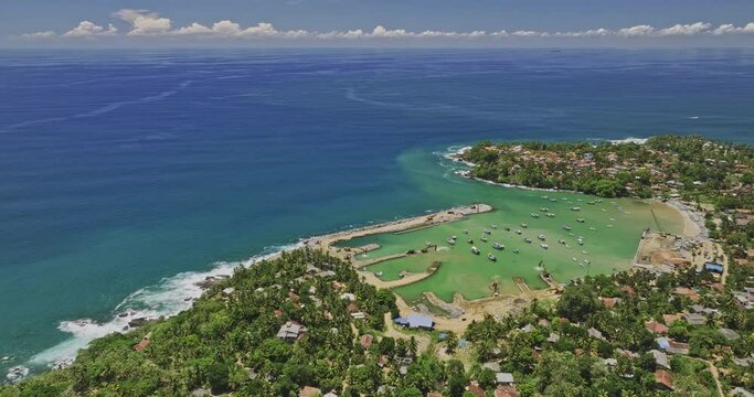 Gandara Sri Lanka Aerial v2 birds eye view, flyover coastal village town capturing fishermen harbour, sandy beach, residential neighborhood and Indian ocean views - Shot with Mavic 3 Cine - April 2023