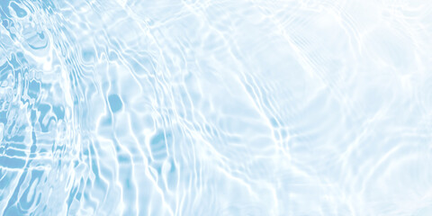 Water waves surface hits the sunlight (soft image). Blue swimming pool water background.