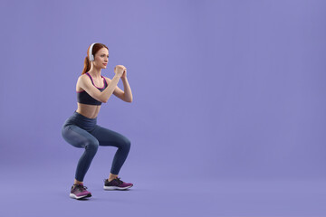 Woman in sportswear doing exercises on violet background, space for text