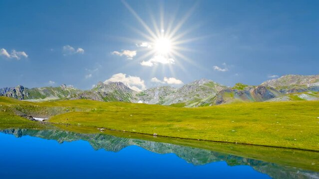  blue calm lake in mountain valley under sparkle sun, mountain travel time lapse scene
