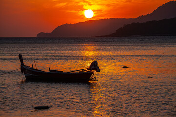 amazing yellow sky of sunrise above the island. .The brilliant yellow hue of the sky created a breathtaking scene as the sun slowly rose over the island..fishing boats parking on the golden sea.