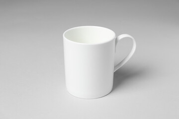 White ceramic mug on light grey background