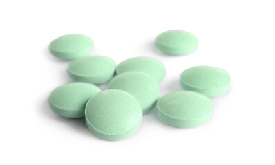 Fototapeta na wymiar Many light green pills isolated on white