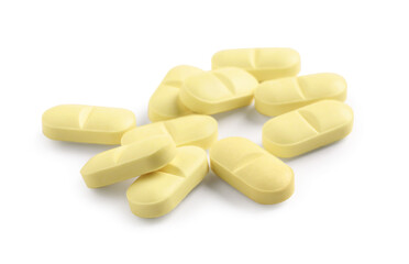 Many yellow pills isolated on white. Medicinal treatment