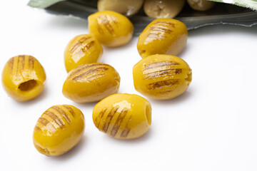 Grilled green olives on white background