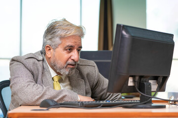 Fototapeta premium Indian Senior businessman giving sad expression at office