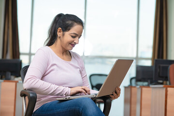 Young indian woman using laptop at office.